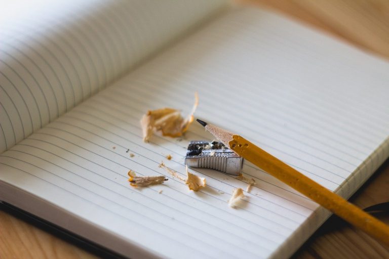 pencil and pencil shavings on a blank notebook